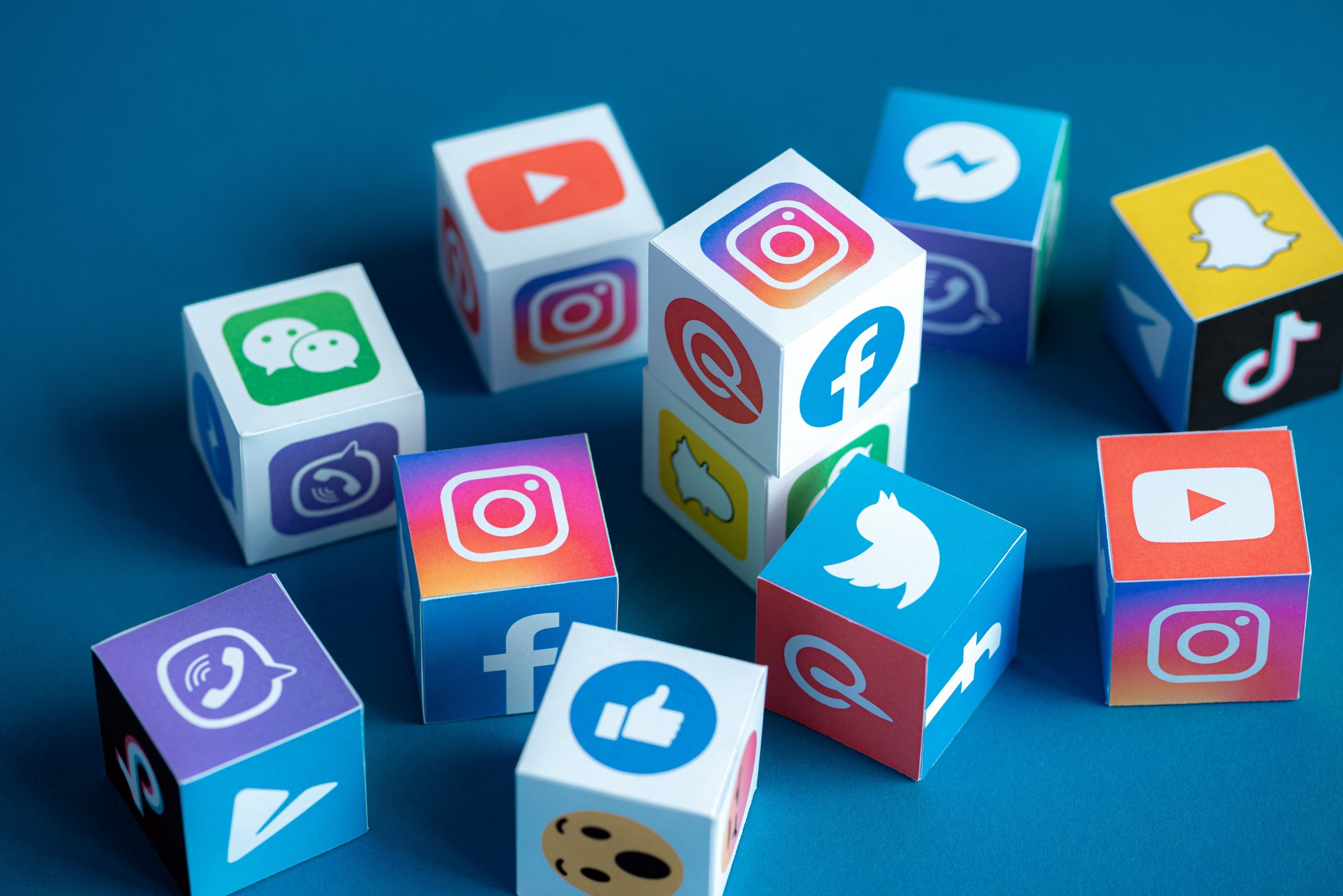 Colorful blocks with social media icons like Facebook, Instagram, YouTube, and Snapchat, representing various social platforms.