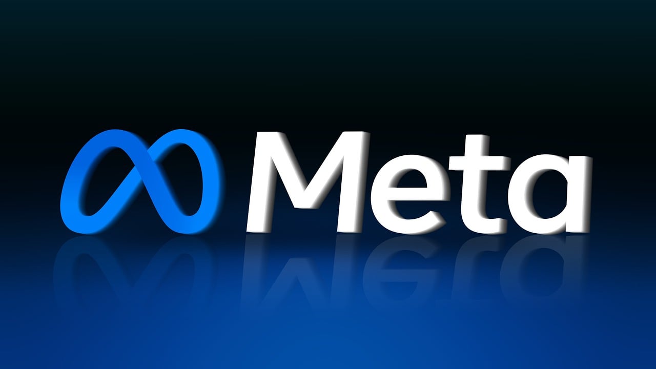 "The 'Meta' logo and wordmark rendered in white and a blue infinity symbol, floating above a dark blue reflective surface."